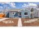 Charming home with a landscaped front yard and pathway leading to the inviting entrance on a sunny day at 4280 S Pearl St, Englewood, CO 80113