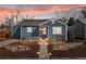 Charming home with a landscaped front yard and pathway leading to the inviting entrance at dusk at 4280 S Pearl St, Englewood, CO 80113