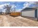 Image features a detached one-car garage with a white door and concrete pad adjacent to a private driveway at 4280 S Pearl St, Englewood, CO 80113