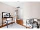 This entry has an accent rug on hardwood floors, a table, and a pair of chairs at 4280 S Pearl St, Englewood, CO 80113