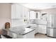 Modern kitchen with white cabinets, sleek countertops, and stainless steel appliances at 4280 S Pearl St, Englewood, CO 80113