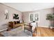 Inviting living room with a stylish couch, modern art, and hardwood floors at 4280 S Pearl St, Englewood, CO 80113