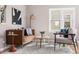 Bright living room featuring modern furnishings, stylish décor, and a large window at 4280 S Pearl St, Englewood, CO 80113