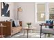 Bright living room with modern furnishings, stylish decor, and ample natural light from the windows at 4280 S Pearl St, Englewood, CO 80113