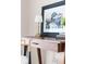 This home office space features a wood desk with a reading lamp and a framed picture at 4280 S Pearl St, Englewood, CO 80113