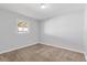 This simple bedroom has neutral paint, carpet, window and a ceiling light at 1185 Worchester St, Aurora, CO 80011