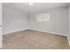 This simple bedroom has neutral paint, carpet, window and a ceiling light at 1185 Worchester St, Aurora, CO 80011