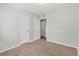 Spacious bedroom with neutral walls, carpeting, and access to additional rooms at 1185 Worchester St, Aurora, CO 80011