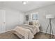 Serene bedroom featuring a large window, soft carpet, and minimalistic decor at 1185 Worchester St, Aurora, CO 80011