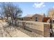 Street view of a brick home with a decorative fence and landscaping in the front at 1185 Worchester St, Aurora, CO 80011