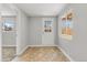 Hallway with neutral paint, and lots of natural light from window and door at 1185 Worchester St, Aurora, CO 80011