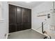 Utility room with storage cabinets, water heater and access to exterior at 1185 Worchester St, Aurora, CO 80011