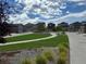 Landscaped green space in a residential neighborhood featuring modern homes and well-maintained lawns, ideal for families at 15600 Bolling, Denver, CO 80239