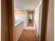 Upstairs hallway with carpet and neutral paint, leading to other rooms in the home at 15600 Bolling, Denver, CO 80239