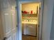 Convenient laundry room featuring a washer and dryer, with storage shelves for organizing laundry essentials at 15600 Bolling, Denver, CO 80239