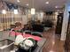 Spacious living area with hardwood floors, decorative curtains, and ample seating for large gatherings at 15600 Bolling, Denver, CO 80239