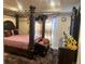 Luxurious main bedroom showcasing a four-poster bed, decorative curtains, and a spacious layout at 15600 Bolling, Denver, CO 80239