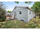 Exterior view of the house with a small deck, a fence and a patch of green grass at 6031 S Pennsylvania St, Centennial, CO 80121