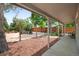 Backyard with an overhang, seating area with a fire pit, benches, and mulch at 6031 S Pennsylvania St, Centennial, CO 80121