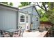 Backyard with a patio table, chairs, fence, and small deck off the back door at 6031 S Pennsylvania St, Centennial, CO 80121