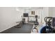 Basement gym with workout equipment and black mats and a window to let the light in at 6031 S Pennsylvania St, Centennial, CO 80121