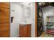 Cozy bathroom and laundry area with washer, dryer, a sink, and wooden cabinets at 6031 S Pennsylvania St, Centennial, CO 80121