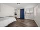 Bright bedroom with hardwood floors and a view of the kitchen, perfect for a convenient, all-in-one living space at 6031 S Pennsylvania St, Centennial, CO 80121
