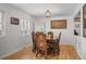 Bright dining room boasts hardwood floors, classic furniture, and ample natural light, perfect for Gathering gatherings at 6031 S Pennsylvania St, Centennial, CO 80121