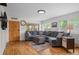 Inviting living room featuring hardwood floors, a comfortable gray sectional, and an abundance of natural light at 6031 S Pennsylvania St, Centennial, CO 80121