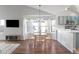 Light-filled dining area with wood floors, a chandelier, and a bay window overlooking outside at 9876 W 106Th Ave, Broomfield, CO 80021