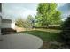 Beautiful backyard with mature trees, a wooden fence, and a concrete patio at 22030 Hill Gail Way, Parker, CO 80138