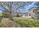 Well-maintained backyard featuring green grass, trees, and a wooden fence at 22030 Hill Gail Way, Parker, CO 80138