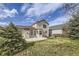 Backyard with a concrete patio, lush green grass, and mature trees at 22030 Hill Gail Way, Parker, CO 80138