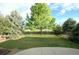 Spacious backyard with lush greenery, mature trees, and a wooden fence for privacy at 22030 Hill Gail Way, Parker, CO 80138