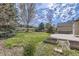 Expansive backyard featuring a lush green lawn, trees, and a wooden fence at 22030 Hill Gail Way, Parker, CO 80138