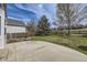 Expansive backyard with a concrete patio, lush green grass, and a wooden fence at 22030 Hill Gail Way, Parker, CO 80138