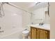 Bright bathroom featuring a shower and tub combo with a mirrored vanity at 22030 Hill Gail Way, Parker, CO 80138