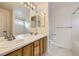 Bathroom featuring a dual sink vanity, a large mirror and tiled floor at 22030 Hill Gail Way, Parker, CO 80138