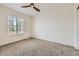 Neutral bedroom with a window for natural light and modern ceiling fan at 22030 Hill Gail Way, Parker, CO 80138