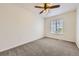 Neutral bedroom with a window for natural light and a modern ceiling fan at 22030 Hill Gail Way, Parker, CO 80138