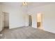 A carpeted bedroom features an open closet and a door leading to an ensuite bathroom at 22030 Hill Gail Way, Parker, CO 80138