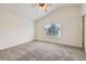 Spacious bedroom with neutral carpet, ceiling fan and a large window with blinds at 22030 Hill Gail Way, Parker, CO 80138