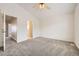 Neutral carpeted bedroom showcasing a doorway leading to the ensuite bathroom at 22030 Hill Gail Way, Parker, CO 80138