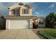 Welcoming two-story home features a spacious driveway, attached garage, and a neatly landscaped front yard at 22030 Hill Gail Way, Parker, CO 80138