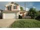 Inviting home with an attached garage, manicured lawn, and bright red door at 22030 Hill Gail Way, Parker, CO 80138