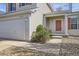 Inviting home entrance features a covered porch, a well maintained lawn and a two-car garage at 22030 Hill Gail Way, Parker, CO 80138