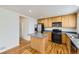 Modern kitchen with stainless steel appliances, an island, and natural wood cabinets at 22030 Hill Gail Way, Parker, CO 80138