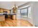 Charming eat-in kitchen area with natural wood floors, light cabinetry, and a lovely bay window at 22030 Hill Gail Way, Parker, CO 80138