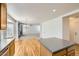 Open kitchen and living room concept with hardwood floors, chandelier, and natural light at 22030 Hill Gail Way, Parker, CO 80138