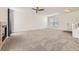 Spacious open-concept living room showcasing plush carpeting, a fireplace, and a front entrance at 22030 Hill Gail Way, Parker, CO 80138